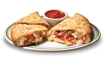 A sliced scalzone and cup of pizza sauce on a plate.